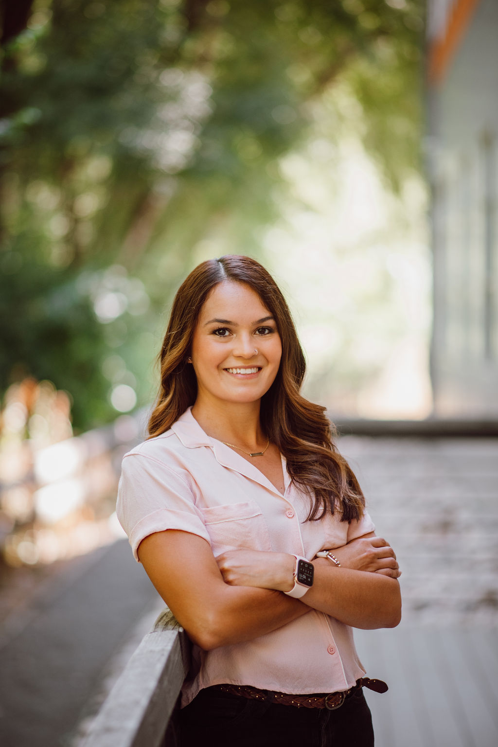 headshot of brillity digital integrator and head of hr/finance, vivianna davis. she is standing with arms crossed, posing in front of an outdoor background