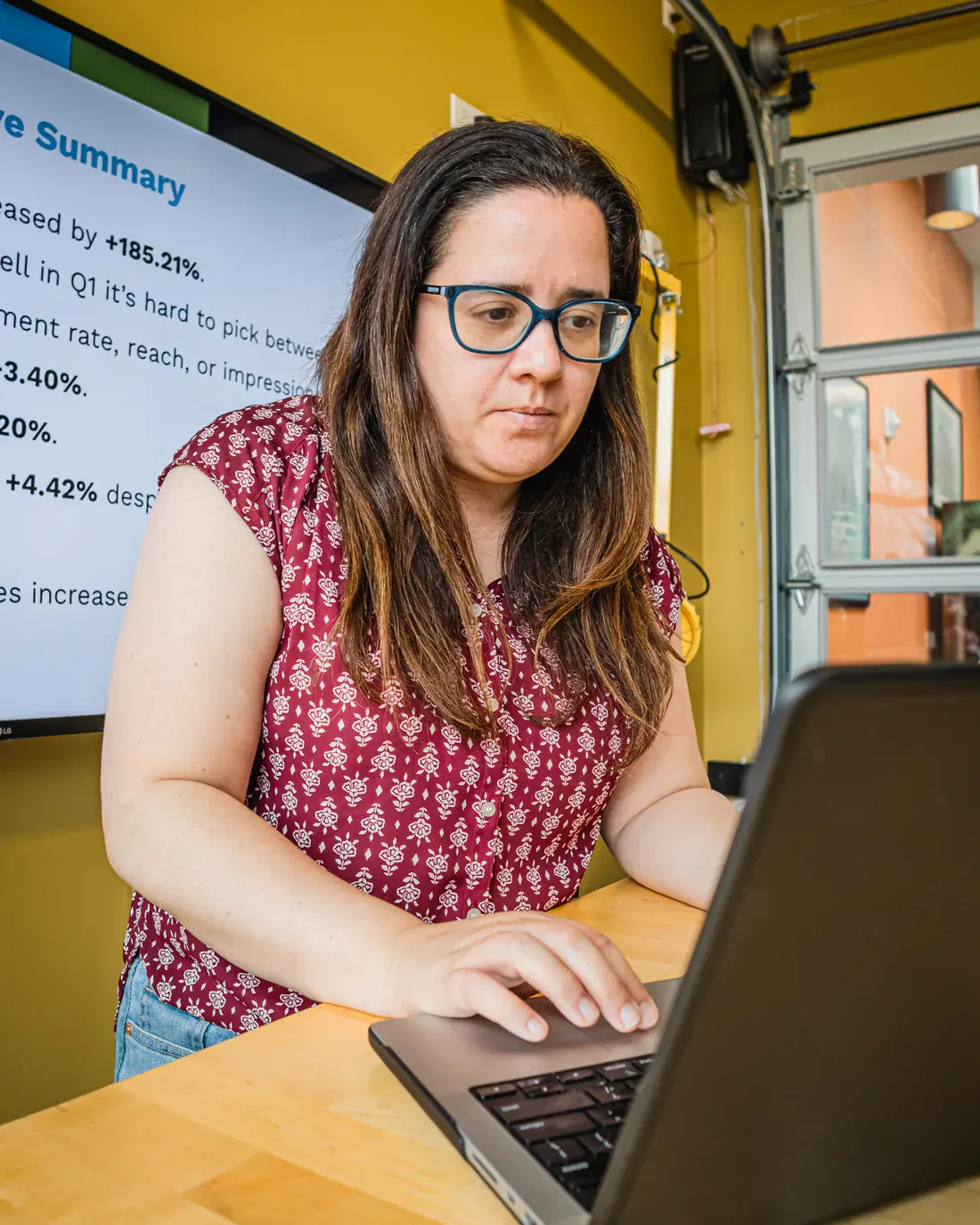 Brillity Digital strategist working on a laptop in the conference room