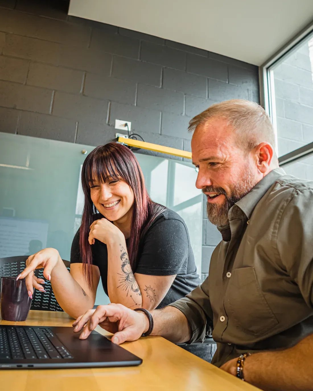 Brillity Digital teammates reviewing client results on a laptop