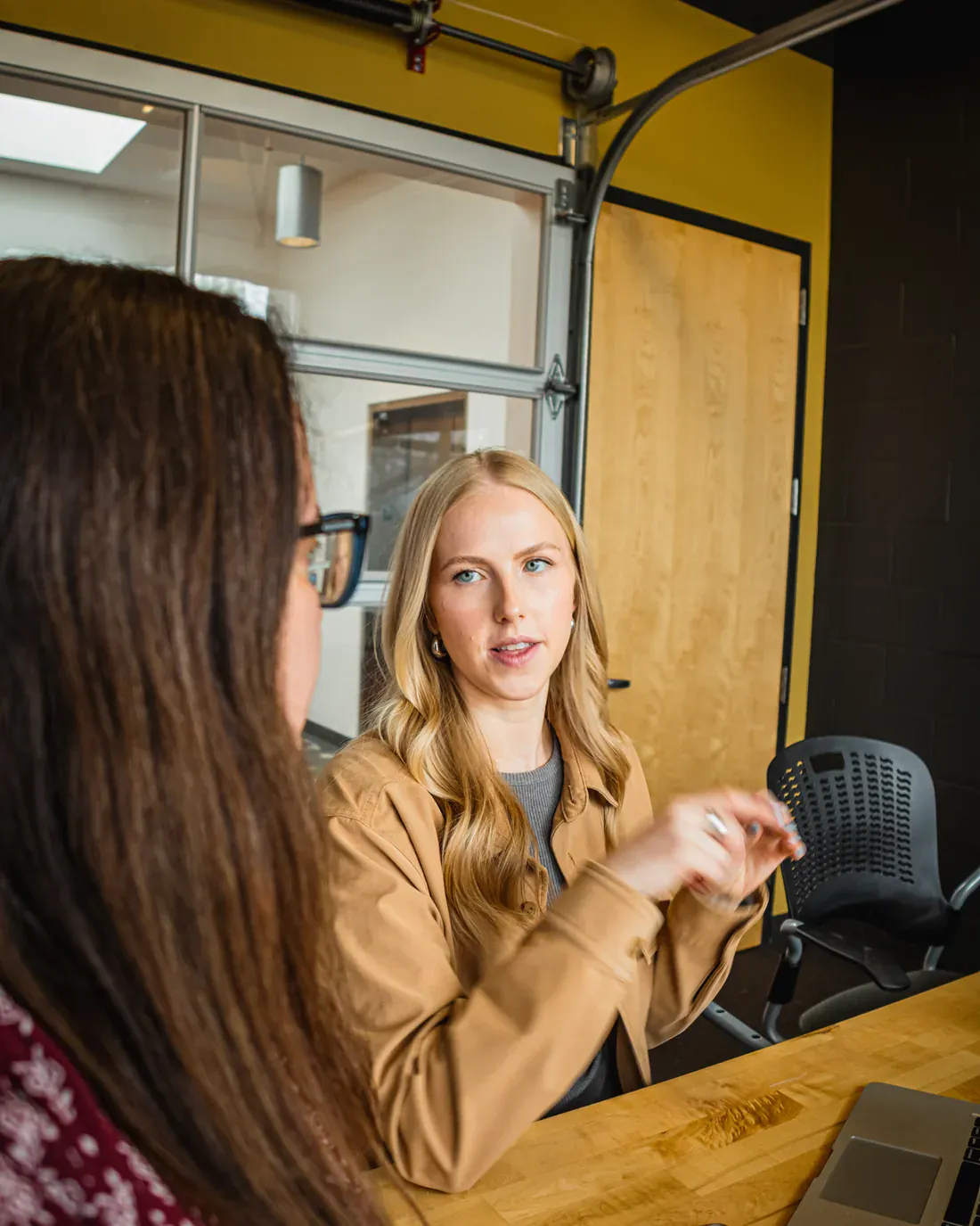 Two Brillity Digital teammates talking through a client strategy