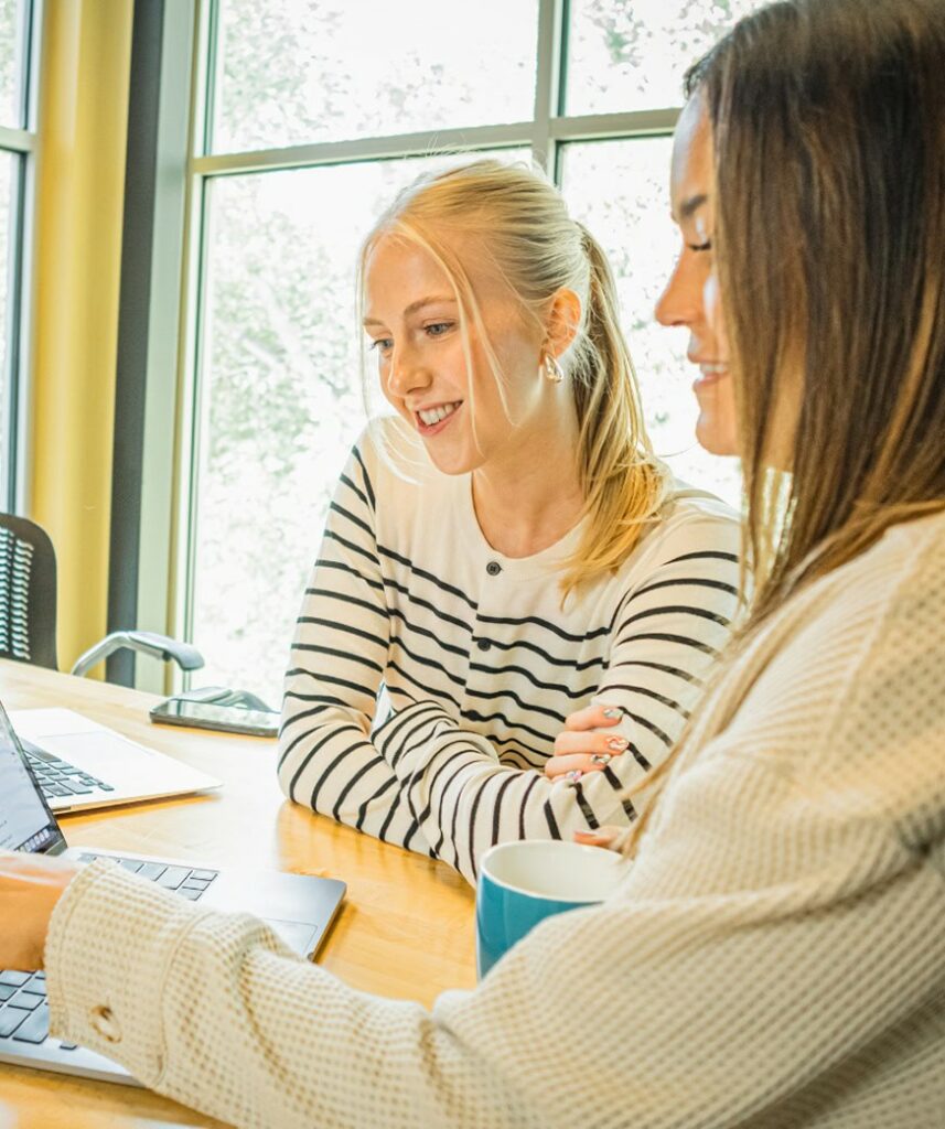 Two Brillity teammates reviewing work together